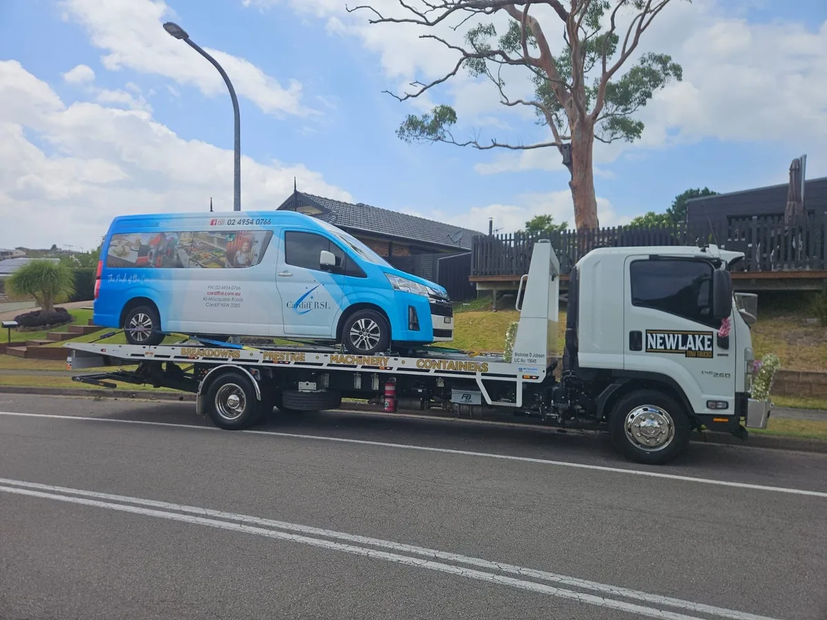 NewLake tilt tray carrying a blue commercial van